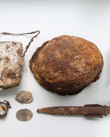Selected items of German equipment found with the German soldiers’ remains: canteen, helmet, mess-tin, bayonet, identity marks, civilian pocket watch