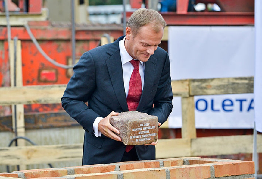 Premier Donald Tusk umieszcza kamień węgielny w cokole, fot. T. Kamiński