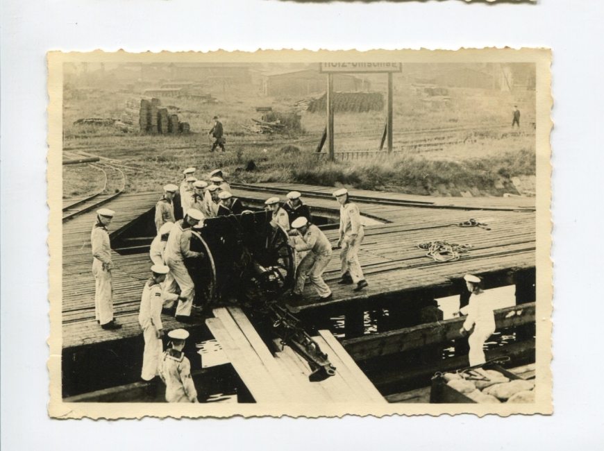 Załadunek polskiej armaty przez marynarzy z okrętu Schleswig-Holstein przy nabrzeżu węglowym w Gdańsku. Na zdjęciu dobrze widać charakterystyczne elementy łoża działa, które jednoznacznie potwierdziły jego dokładną wersję – 76,2 mm. Autor nieznany, wrzesień 1939 r. (MIIWŚ)