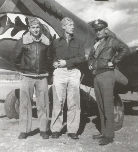 Fot. Witold Urbanowicz (w środku) podczas rozmowy z amerykańskimi pilotami na Dalekim Wschodzie (domena publiczna)